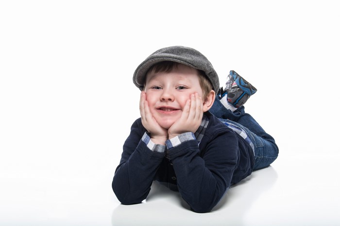 Boy in a cap lying down