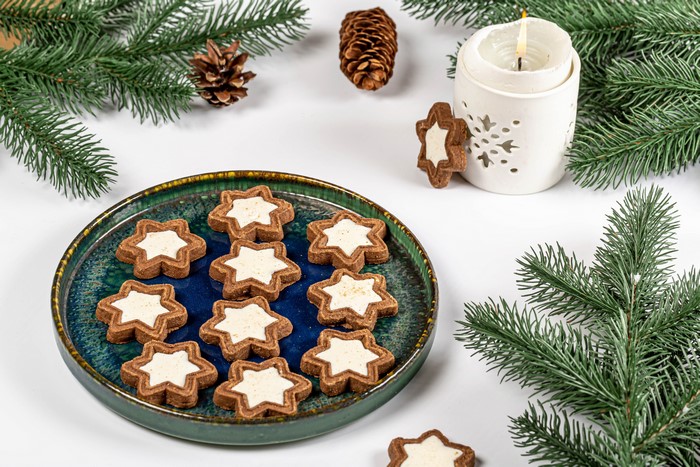 Christmas star cookies with candle and pine cones