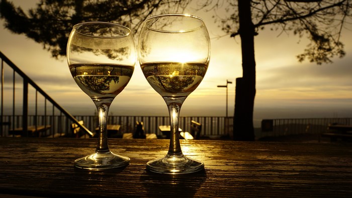 Two glasses of white wine at sunset