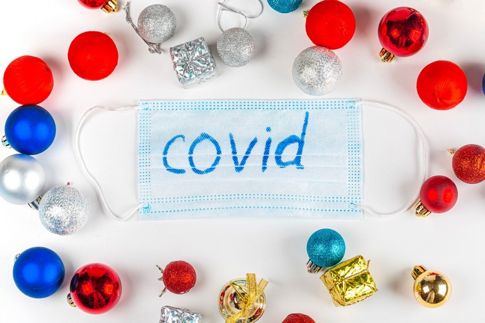 Christmas ornaments and a face mask with the word "covid"