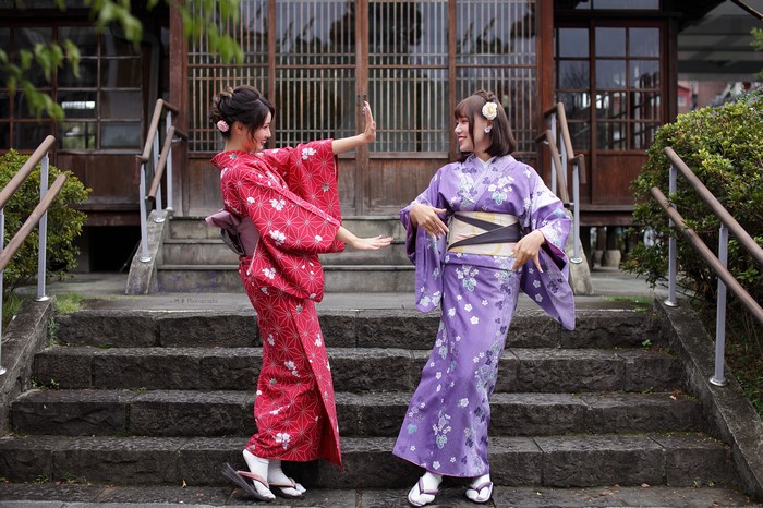 Two Asian women in kimonos smiling