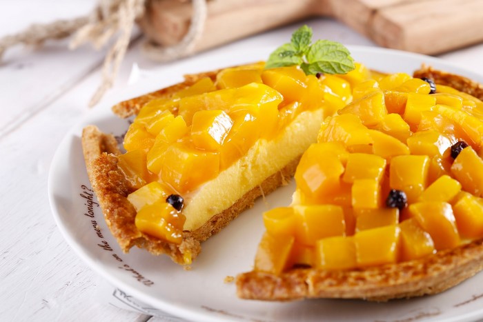 Mango tart with mint on a plate