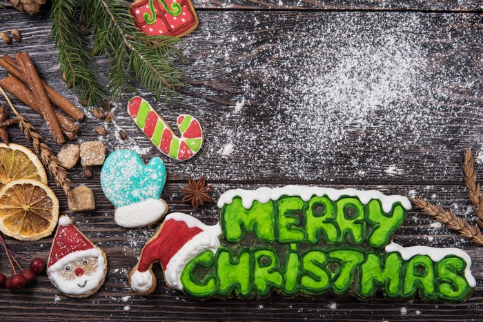 Christmas cookies with powdered sugar on wood
