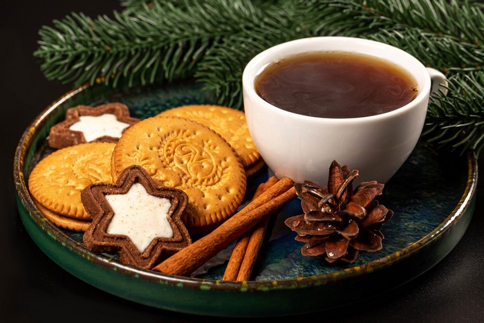 Christmas cookies with tea and pine cone