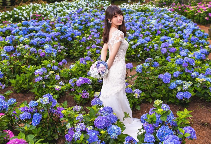 4K Asian Bride Holding Bouquet Among Blue Flowers
