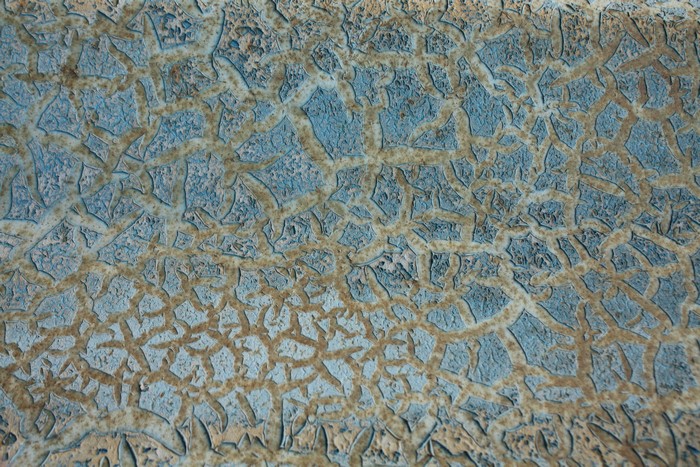 Cracked blue and tan paint texture