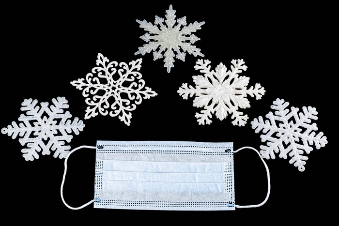 Snowflakes and Coronavirus Mask on Black Background