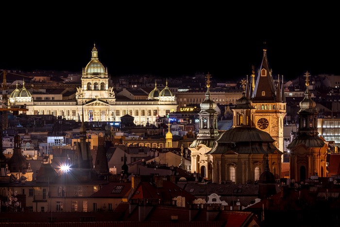 Prague cityscape at night with illuminated buildings and churches