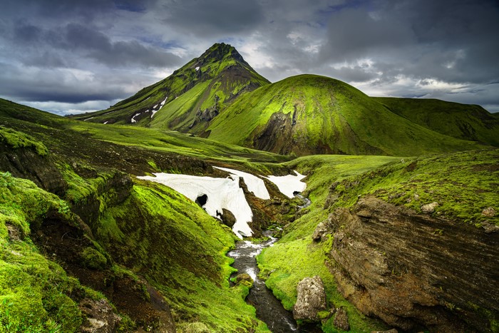 Green mountains and snow patches in Iceland