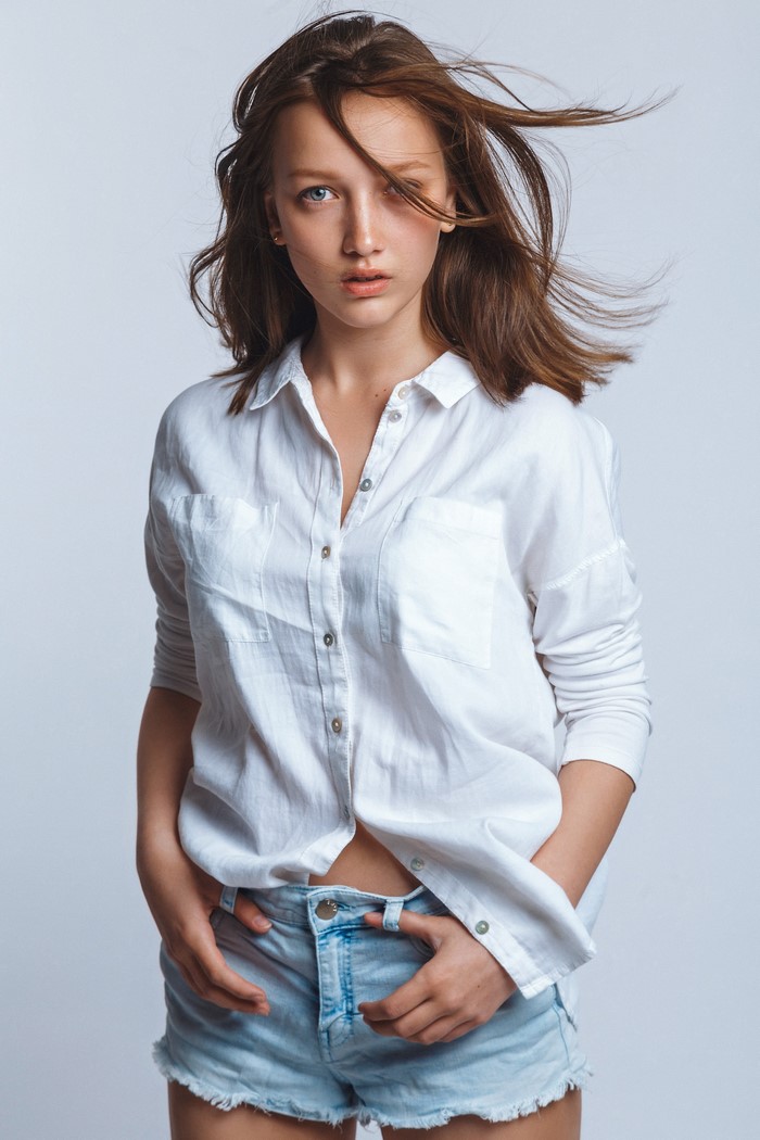 Anna, a brown-haired model in a formal shirt and shorts