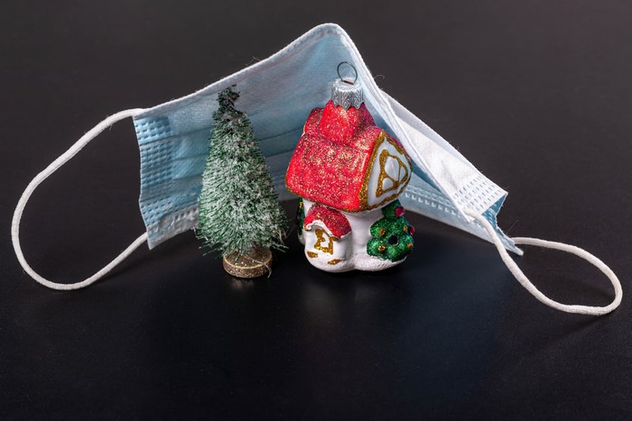 Christmas tree and house ornament under a face mask