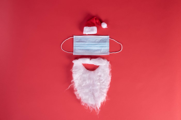 Santa Claus mask and beard on red background