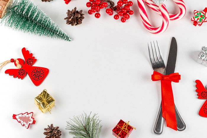 Christmas table setting with fork, knife, and decorations
