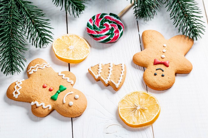 Christmas cookies with lemons and lollipop on wood