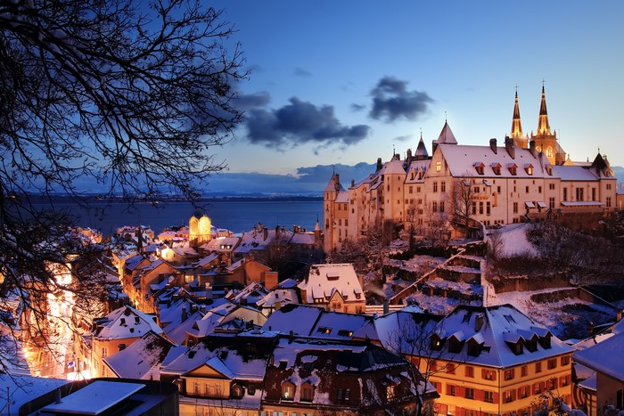 Chillon Castle and town by Lake Geneva at dusk in winter