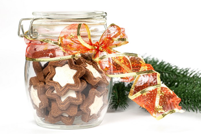 Christmas cookies in a jar with ribbon and pine branch