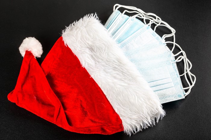 Santa hat and face masks on a dark background