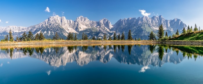 Panorama of the Alps mountains reflected in a lake in Tyrol, Austria