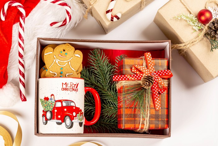 Christmas gift box with mug, cookies, and presents