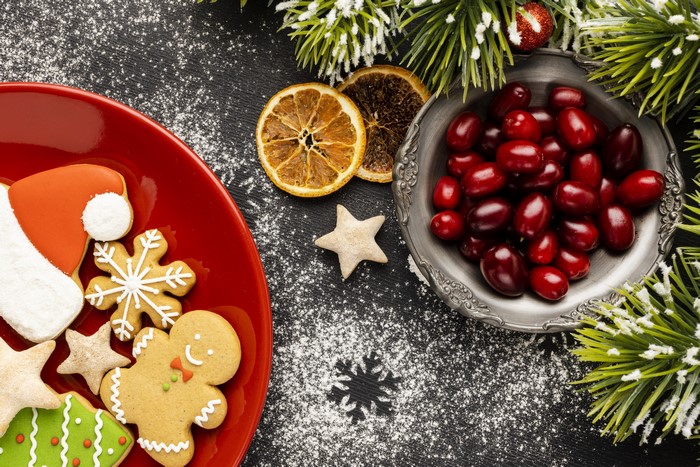 Christmas cookies and berries with pine branches