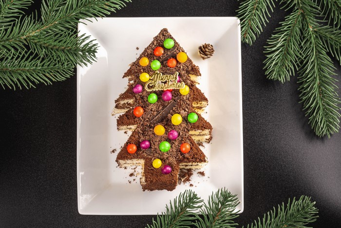 Christmas tree cake with candies and pine cone