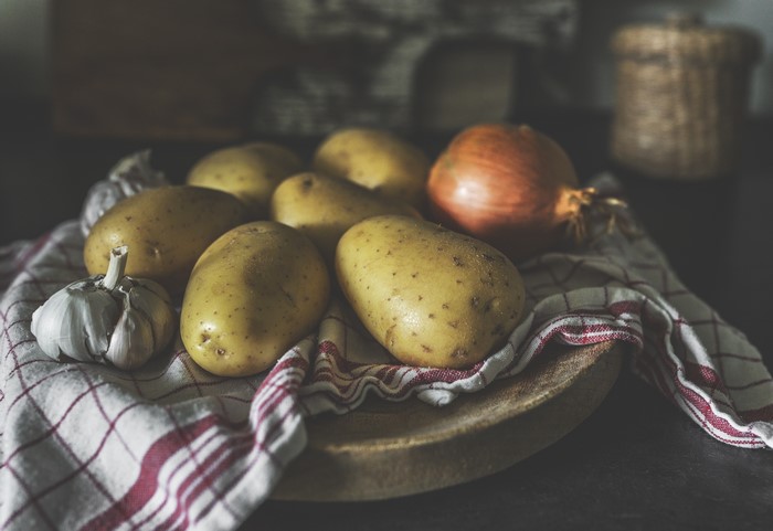 Potatoes, Onion, and Garlic on a Checked Cloth