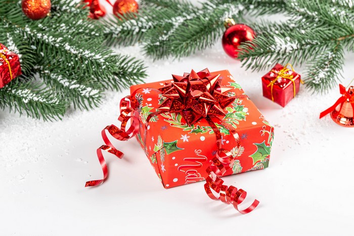 Christmas gift with pine branches and ornaments