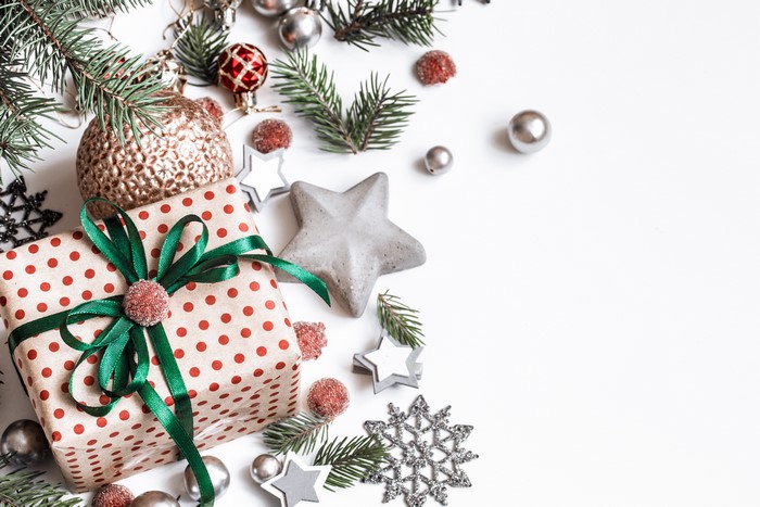 Christmas gift with ornaments and pine branches