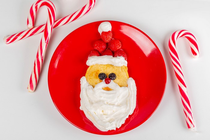 Santa Claus pancake with strawberries and candy canes