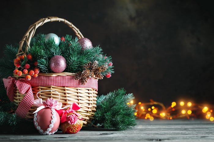 Christmas basket with ornaments and pine branches