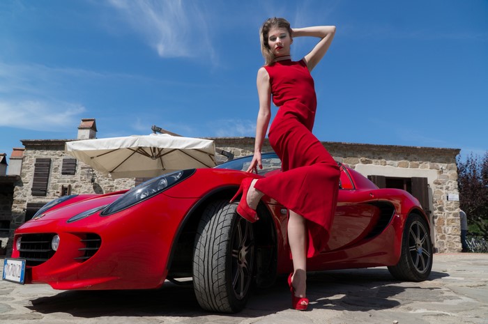 Elisa Pagano posing with a red Lotus Elise
