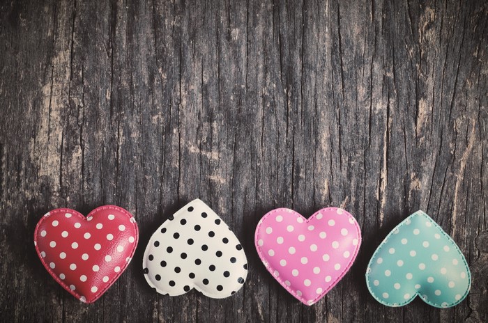 Four Polka Dot Hearts on Wooden Background