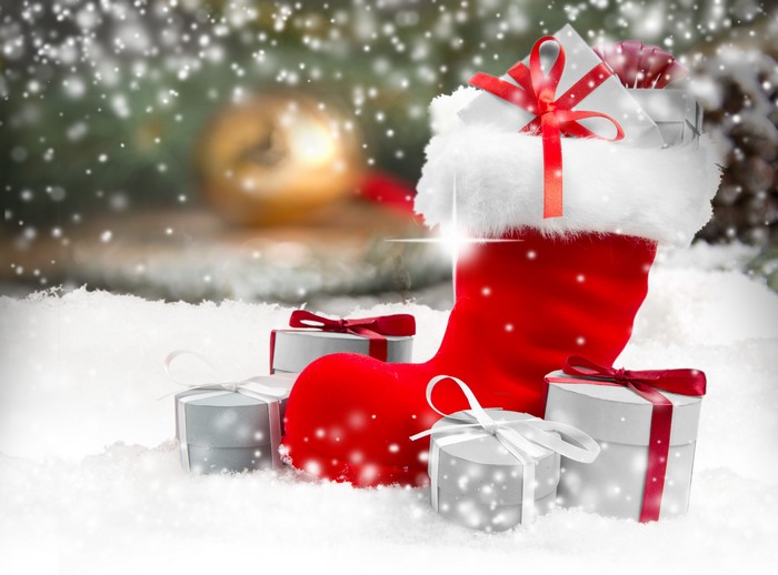 Christmas stocking with gifts in snow