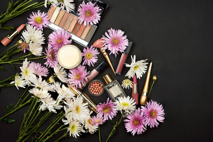 Cosmetics and Chrysanthemums on a Gray Background