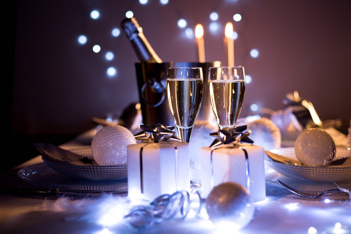 Champagne glasses and gifts with Christmas lights