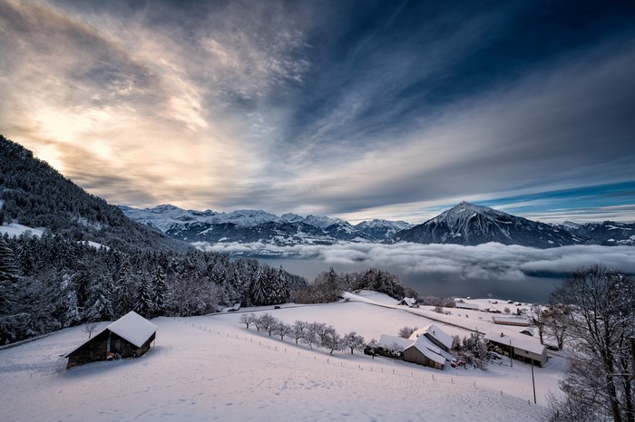 Winter landscape with snow-covered mountains and lake in Switzerland