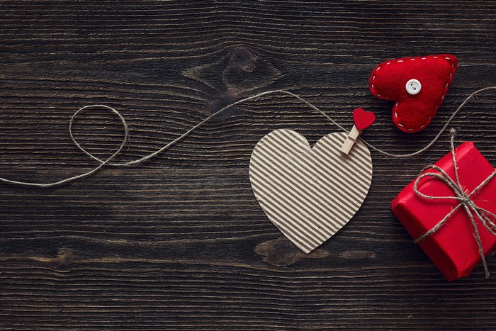 Valentine's Day hearts and gift on wood