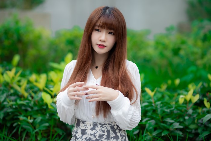 Asian woman with brown hair and hands