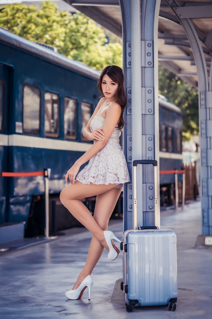 Asian Woman in White Dress with Suitcase