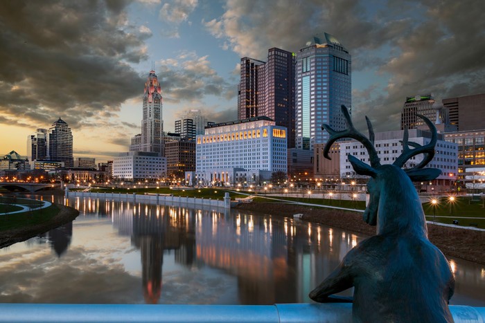 Deer sculpture overlooking Columbus, Ohio skyline at dusk
