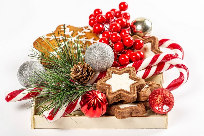 Christmas cookies, candy canes, and ornaments on a tray