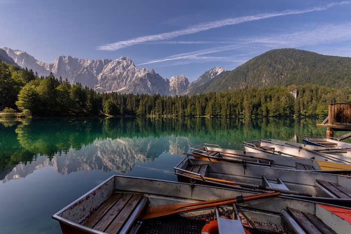 Boats on Fusine Lakes with Alps Reflection