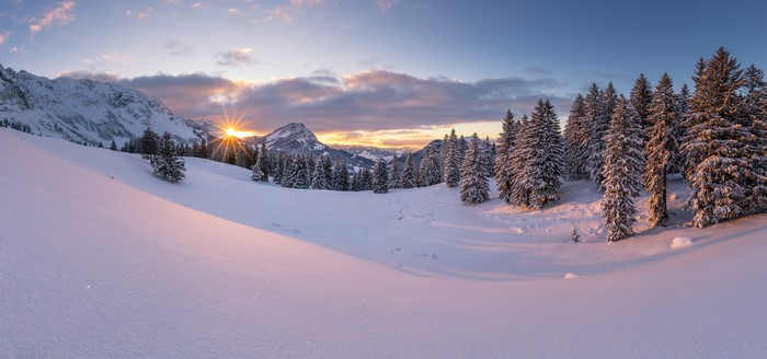 Panorama of snow-covered Alps in Switzerland at sunrise
