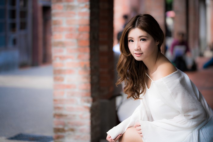 Asian woman with brown hair in white dress