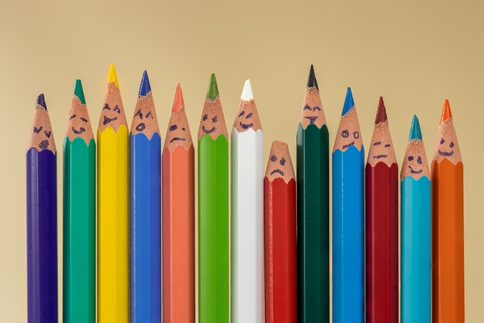 Pencils with faces on a colored background