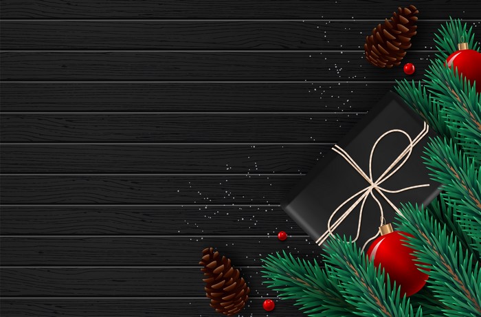 Christmas Gift with Pine Cones and Ornaments on Wood