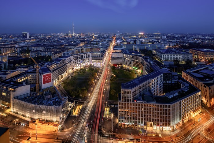 Berlin cityscape at night with light trails from above