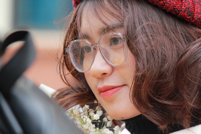 Close-up of a young Asian woman with glasses