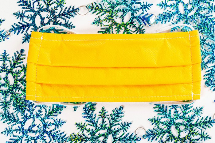 Yellow face mask with snowflakes