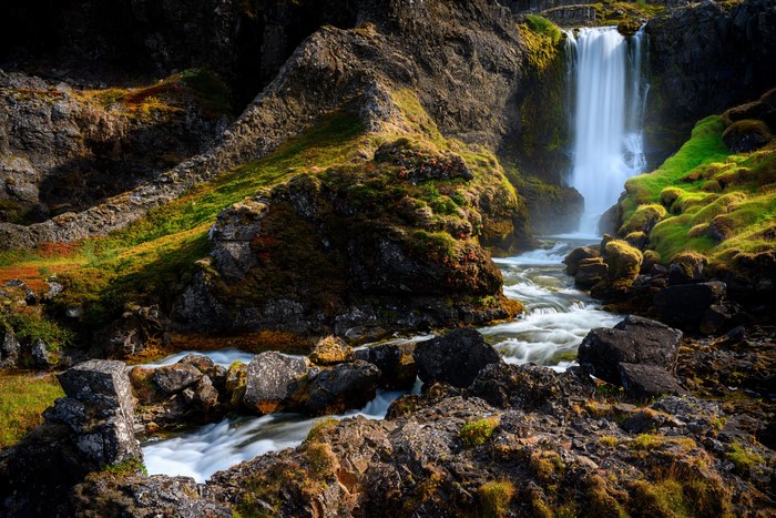 Waterfall cascading over mossy rocks in Iceland